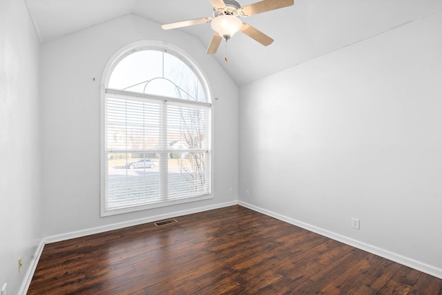 empty room with ceiling fan, dark wood-type flooring, and lofted ceiling