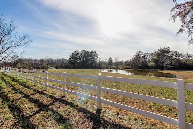 view of yard with a rural view and a water view