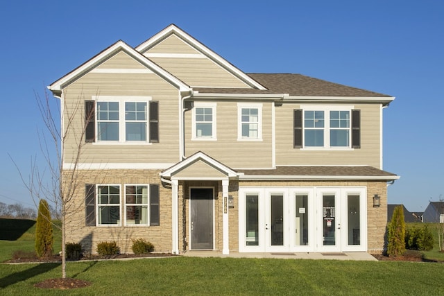 view of front of house featuring french doors and a front yard