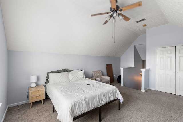 carpeted bedroom featuring vaulted ceiling, ceiling fan, a closet, and a textured ceiling