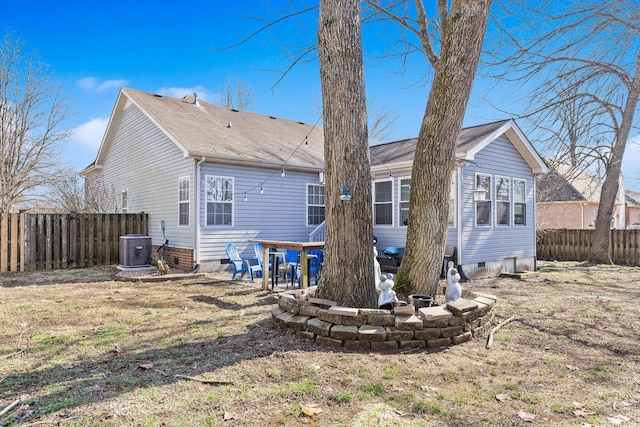 rear view of property with a yard and central AC