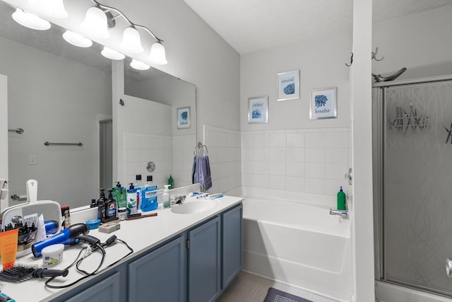 bathroom featuring separate shower and tub, vanity, and tile patterned flooring