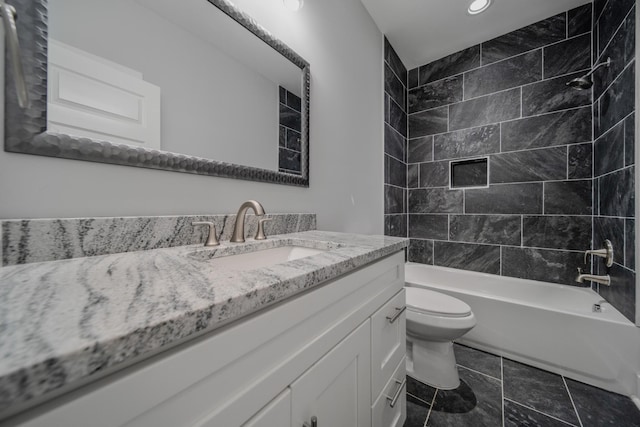 full bathroom with vanity, toilet, and tiled shower / bath