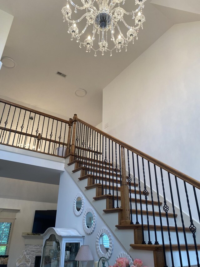 5107 General Eisenhower Dr, Murfreesboro, TN 37129 - stairway featuring a chandelier, high vaulted ceiling, and visible vents
