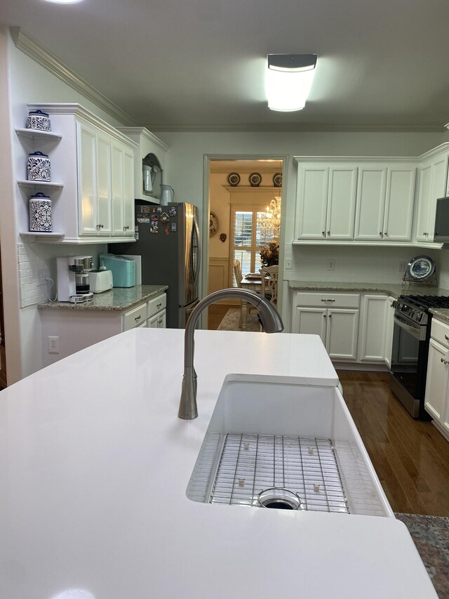 5107 General Eisenhower Dr, Murfreesboro, TN 37129 - kitchen featuring dark wood-style floors, ornamental molding, stainless steel appliances, white cabinetry, and open shelves
