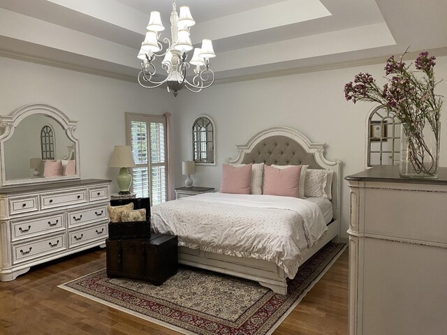 5107 General Eisenhower Dr, Murfreesboro, TN 37129 - bedroom with dark wood-style floors, a raised ceiling, and an inviting chandelier