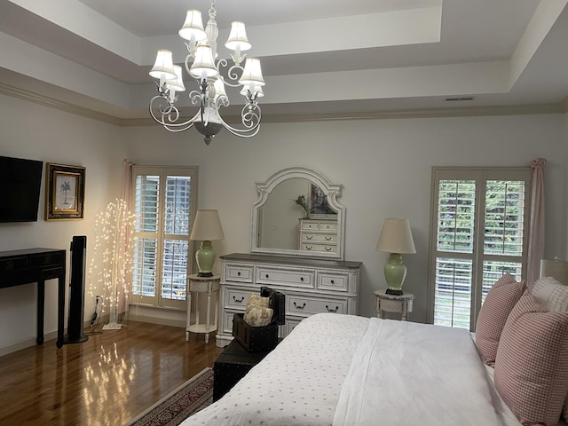 5107 General Eisenhower Dr, Murfreesboro, TN 37129 - bedroom with baseboards, visible vents, dark wood-type flooring, a tray ceiling, and a notable chandelier