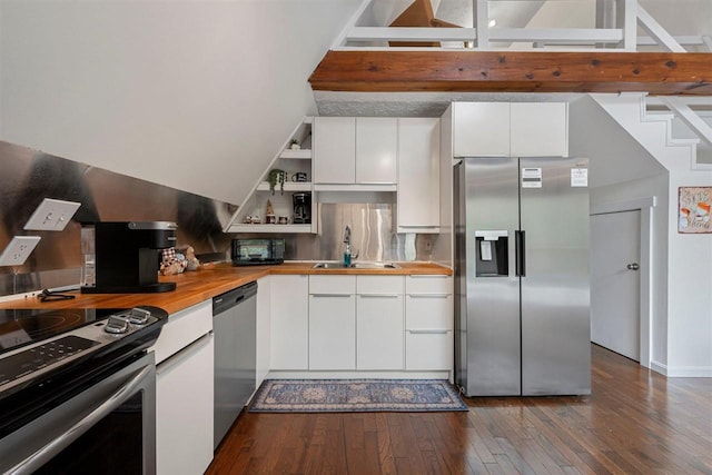 kitchen with wooden counters, stainless steel appliances, sink, white cabinetry, and dark hardwood / wood-style floors