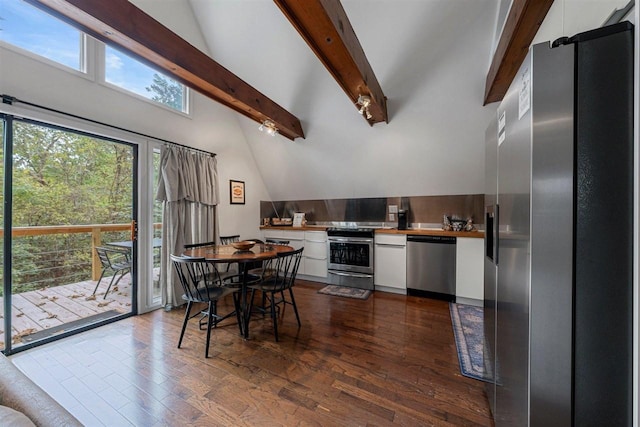 kitchen with appliances with stainless steel finishes, beamed ceiling, dark hardwood / wood-style floors, and white cabinets