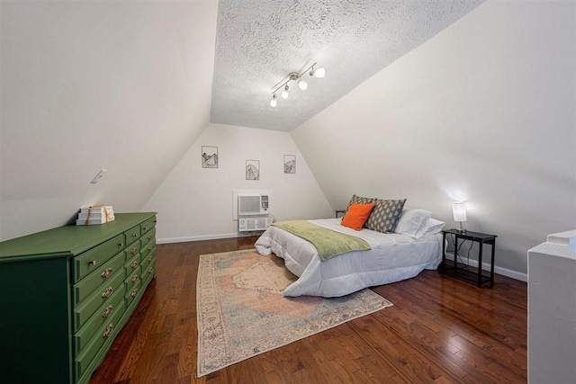 bedroom featuring a textured ceiling, lofted ceiling, and dark hardwood / wood-style floors