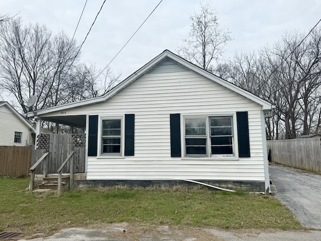 view of property exterior with a yard