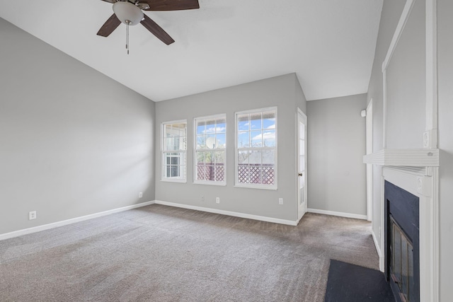 unfurnished living room featuring ceiling fan, a large fireplace, vaulted ceiling, and carpet floors