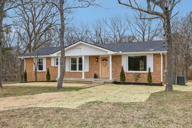 ranch-style house featuring central air condition unit and a front yard