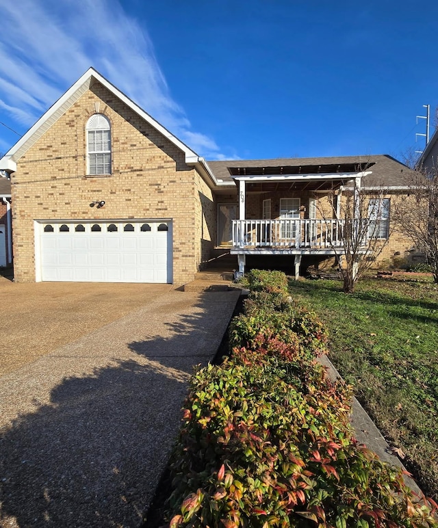 ranch-style house featuring a garage, covered porch, brick siding, and concrete driveway