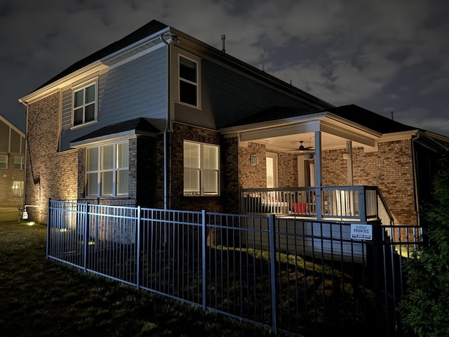 exterior space with covered porch, fence, and a ceiling fan