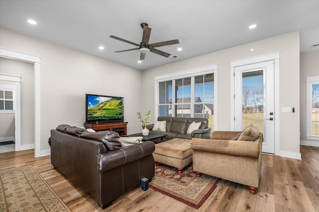 living room with ceiling fan and light hardwood / wood-style floors