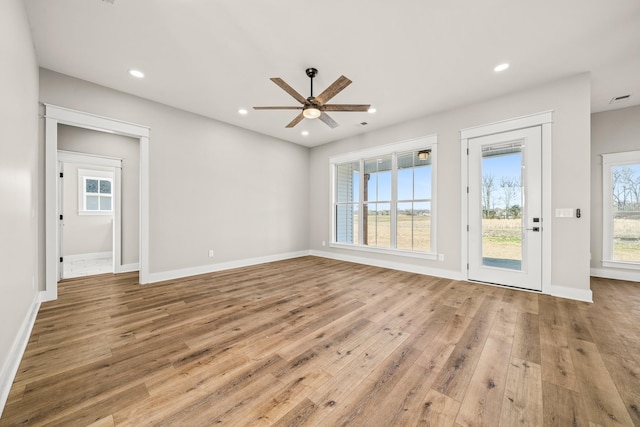 unfurnished living room with ceiling fan, light hardwood / wood-style floors, and a healthy amount of sunlight