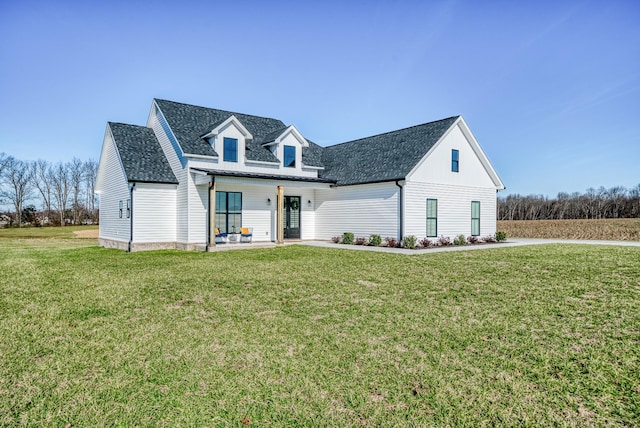 cape cod home featuring a front lawn