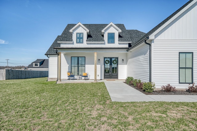 view of front of home featuring french doors, a front yard, and a porch