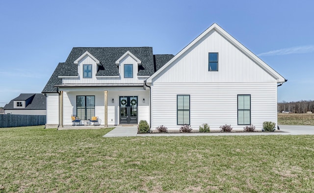 view of front facade featuring a front yard, french doors, and a porch