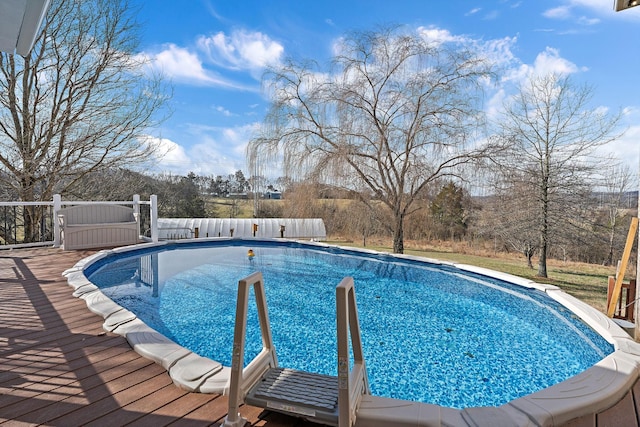 view of swimming pool featuring a wooden deck