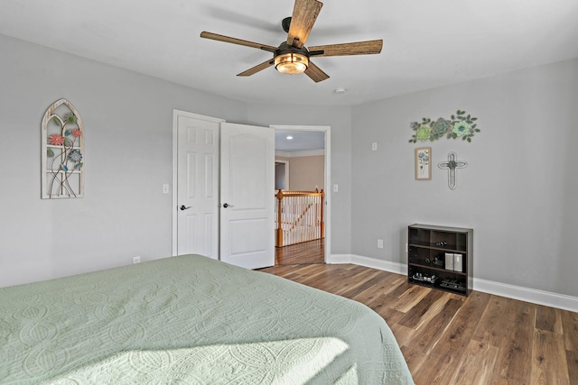 bedroom with ceiling fan and dark hardwood / wood-style floors