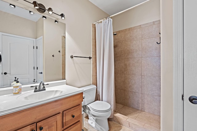 bathroom with toilet, vanity, tile patterned flooring, and curtained shower