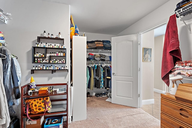 walk in closet featuring light carpet