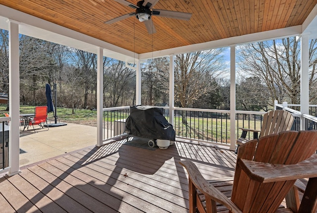 deck featuring area for grilling and ceiling fan