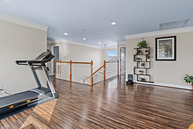 workout area featuring dark wood-type flooring and crown molding