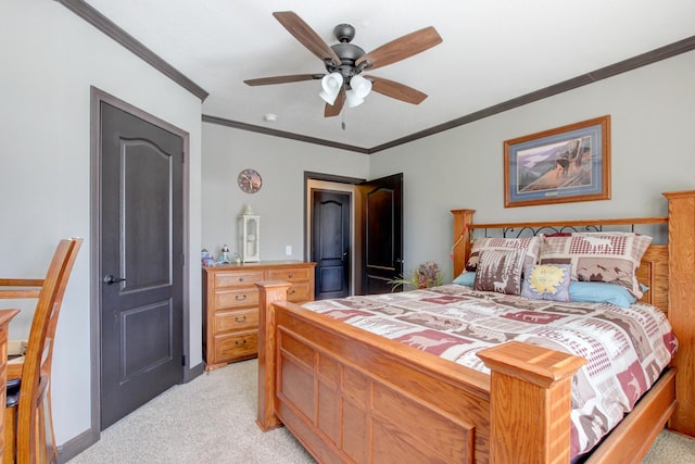 carpeted bedroom featuring crown molding and ceiling fan