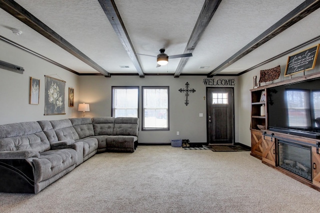 carpeted living room with beamed ceiling and a textured ceiling