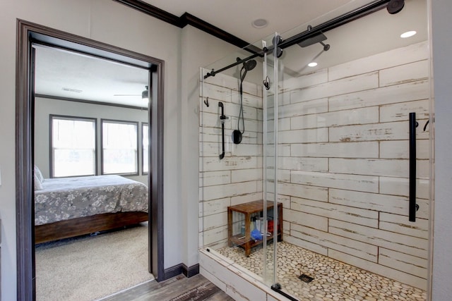 bathroom with wood-type flooring, ornamental molding, and walk in shower