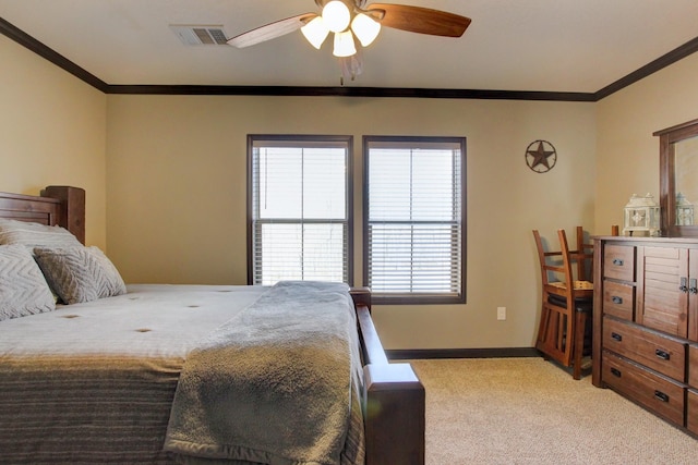 carpeted bedroom with ceiling fan and ornamental molding