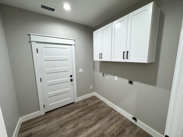 laundry area with dark hardwood / wood-style floors, cabinets, and electric dryer hookup