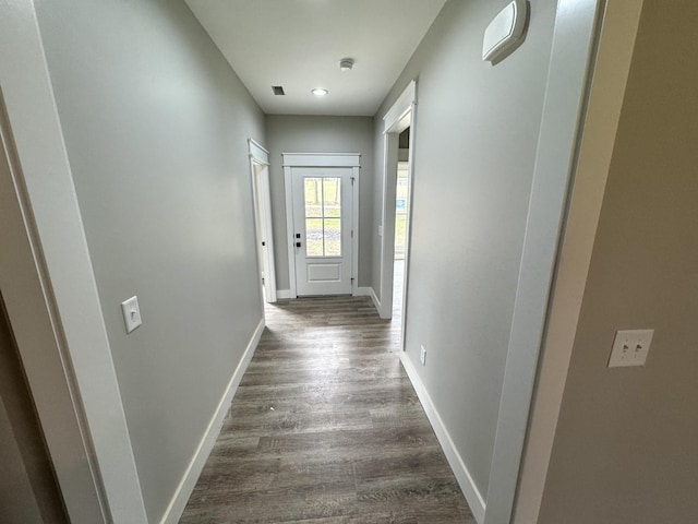 corridor featuring dark hardwood / wood-style flooring