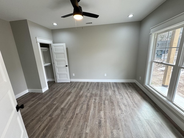 unfurnished bedroom with ceiling fan and dark hardwood / wood-style flooring