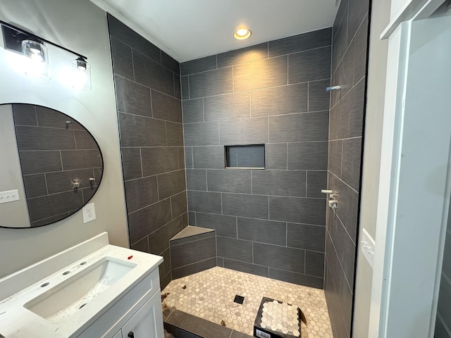 bathroom with vanity and tiled shower