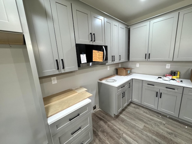 kitchen featuring gray cabinetry and hardwood / wood-style floors