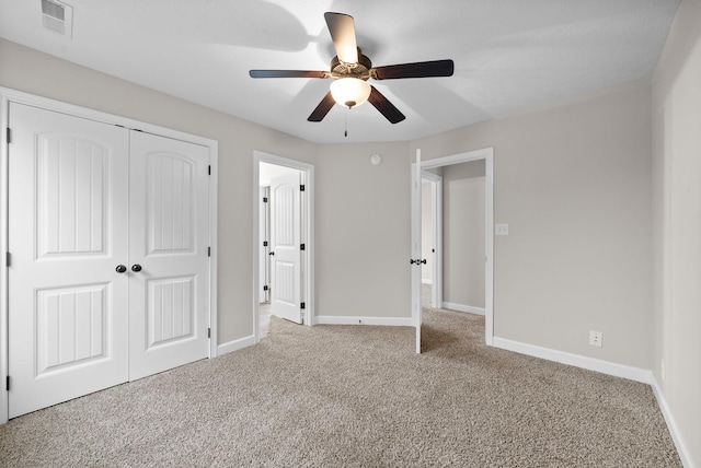 unfurnished bedroom with light carpet, ceiling fan, and a closet