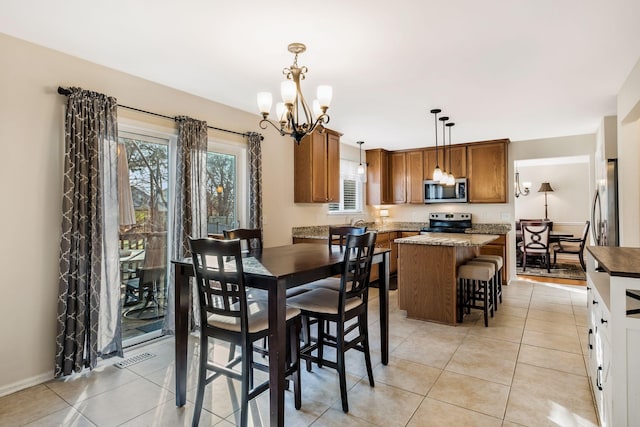 tiled dining space featuring a notable chandelier