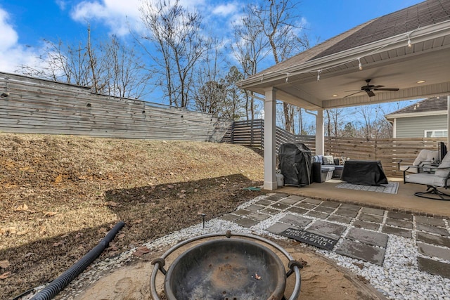 view of patio featuring a fire pit, ceiling fan, and grilling area