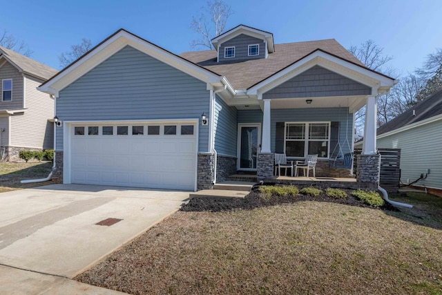 craftsman-style home with stone siding, a garage, covered porch, and driveway