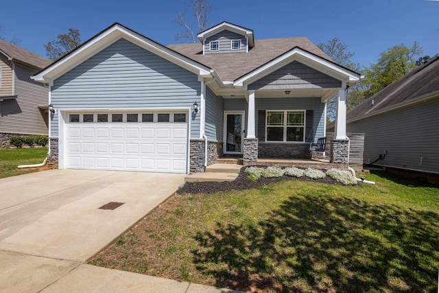 view of front of home featuring covered porch, driveway, stone siding, and a front lawn