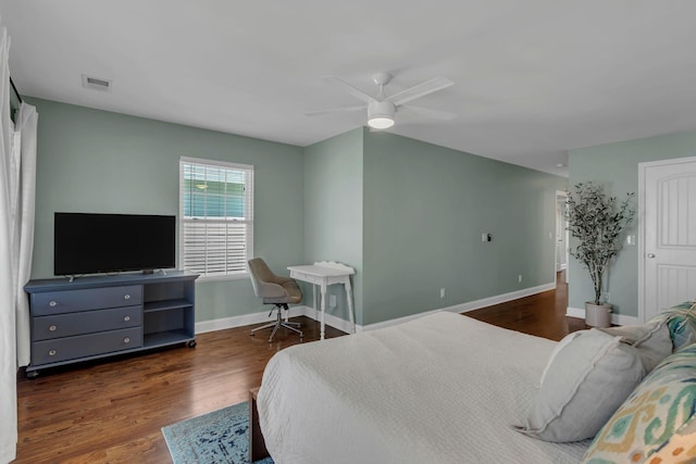 bedroom with dark hardwood / wood-style flooring and ceiling fan