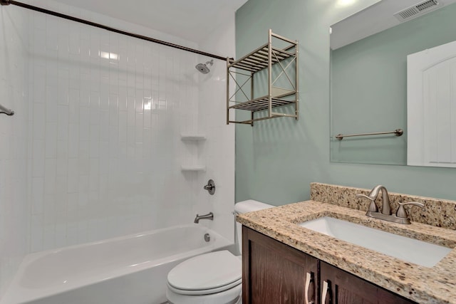 full bathroom featuring tiled shower / bath combo, vanity, and toilet