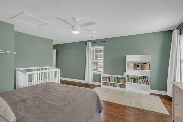 bedroom with ceiling fan and dark hardwood / wood-style flooring