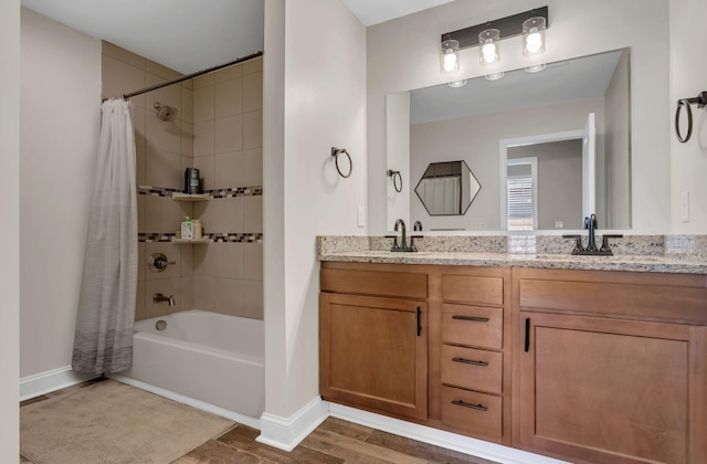 bathroom featuring hardwood / wood-style flooring, shower / bathtub combination with curtain, and vanity