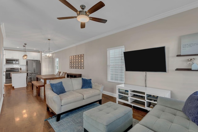 living room featuring dark wood-type flooring, crown molding, and ceiling fan with notable chandelier