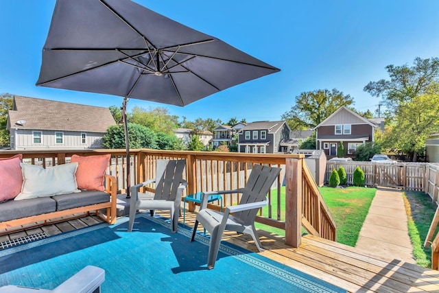 wooden deck featuring a lawn